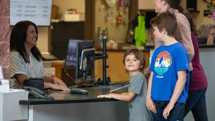 Family registering at front desk
