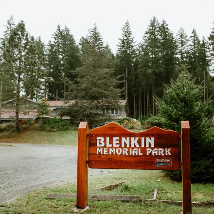 Blenkin Memorial Park entrance sign with trees in the background.