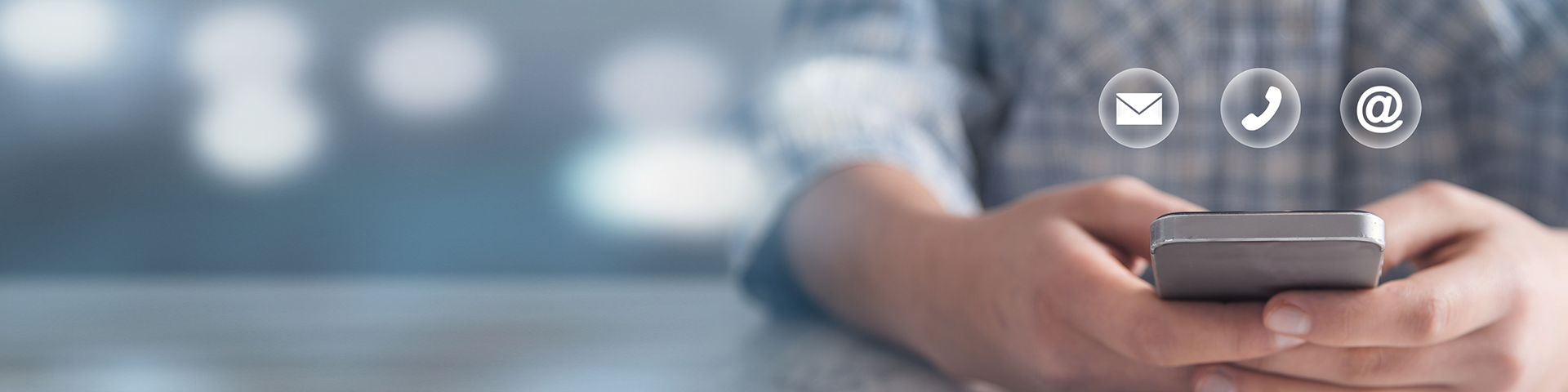 Person holding phone with email and phone symbols